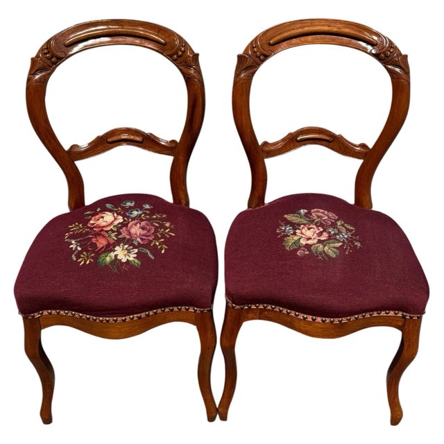 Pair of antique circa 1880 Victorian walnut side chairs with burgundy floral needlepoint upholstery and newly French-...