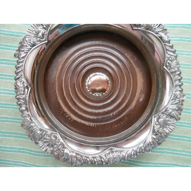 This fabulous Corbell & Company wine coaster is created in a gorgeous electroplated silver plate with a marvelous shell...