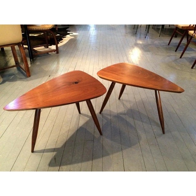 A near pair of sculpted tripod triangular tables in American Walnut studio crafted by Phil Powell in his New Hope Studio....