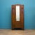 A 1930s oak wardrobe with a single mirrored door. The front features carved detailing and vertical reeded decoration...