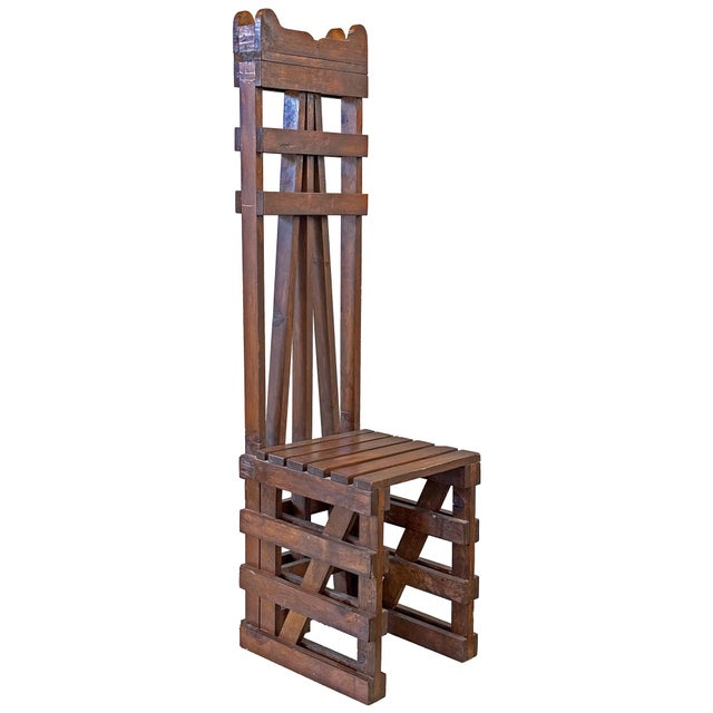 A monumental folk art wood slat ladder back chair. An architectural, utilitarian, homespun homage to an classic seating...