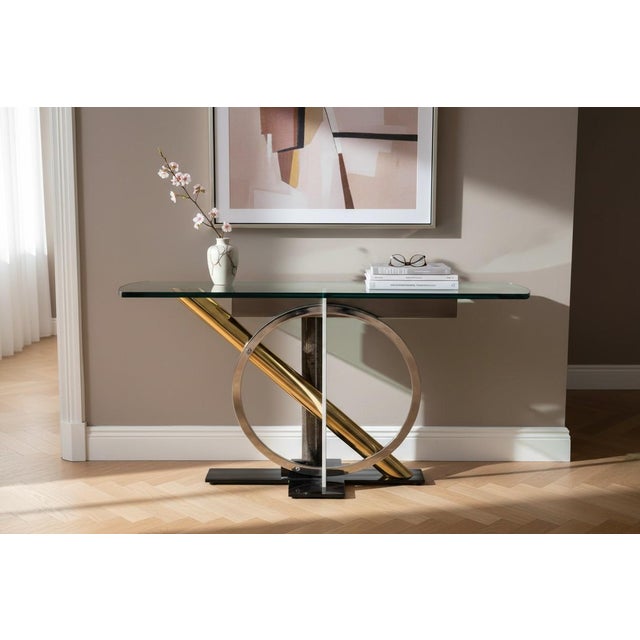 This striking 1980s Postmodern console table features a bold sculptural base crafted from polished chrome, brass-plated...