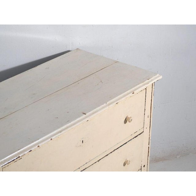 Antique painted pine chest of drawers from Central Europe, dating to around 1900, featuring a distressed rustic finish and...