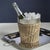 A stunning fusion of natural woven rattan and nickel-finished steel, this wine bucket adds a rustic yet refined touch to...