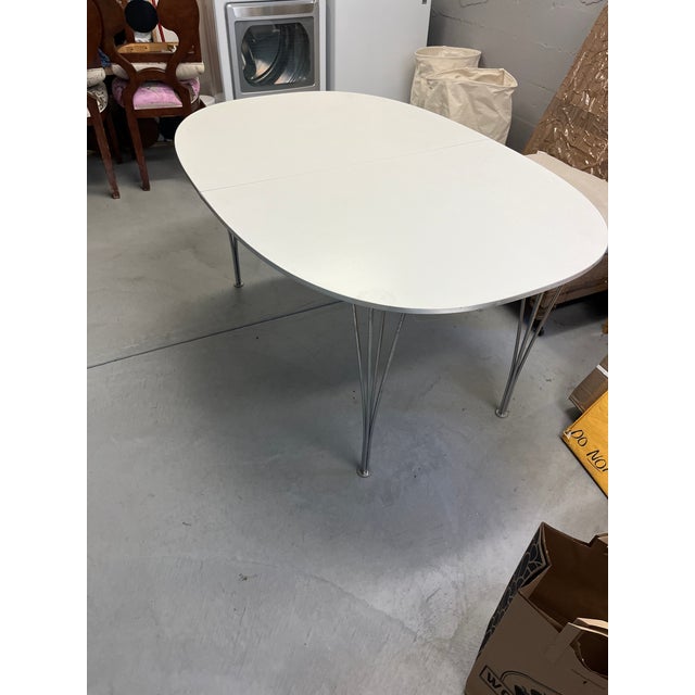 This is a Piet Hein and Mathsson dining table. I have 2 extension panels.. Chrome Laquer. It is not signed.,