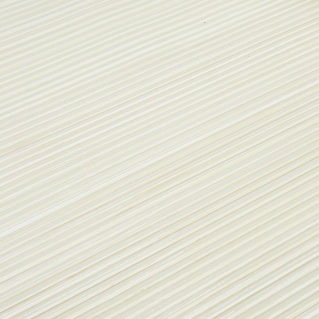 Created by hand, Rimini Rib is a lustrous metallic wallcovering with a pronounced corded texture. A wash of color...