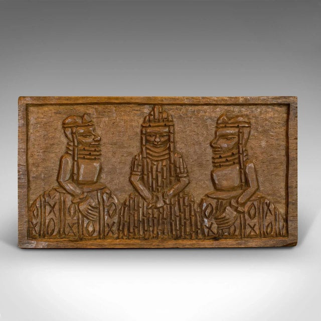This is a vintage hand carved wooden plaque. An Asian hardwood, naive decorative tribal scene, dating to the early 20th...