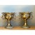 This vintage pair of urns is cast in solid-looking brass in a Baroque-revival manner, each built as a footed, pedestal-...