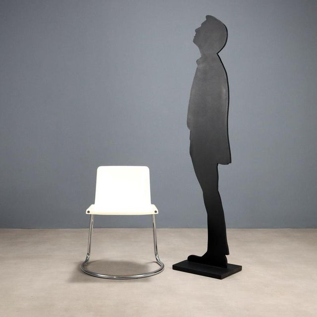 Vintage chair with chromed tubular leg and white plastic seat. This piece is attributed to the mentioned designer/maker....