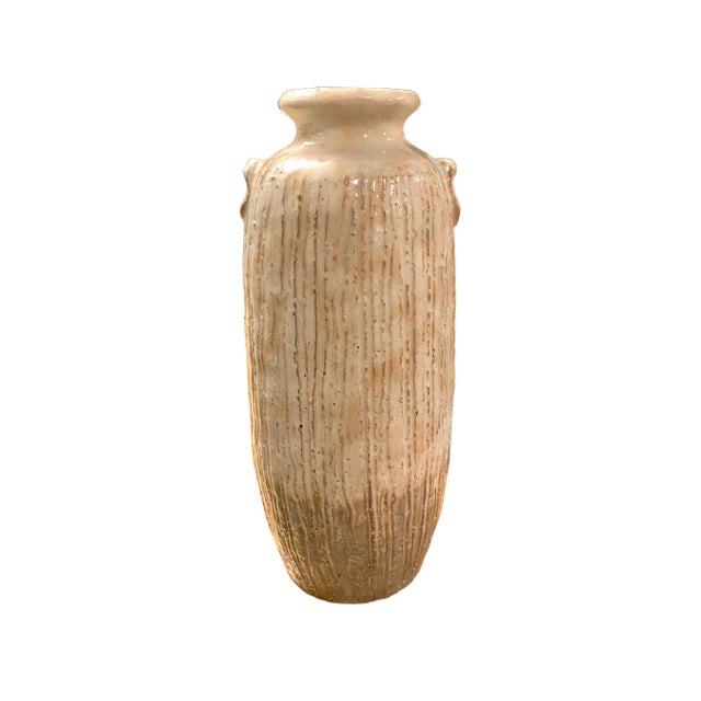 This striking Japanese stoneware vase embodies the timeless wabi-sabi aesthetic, celebrating natural texture, subtle...