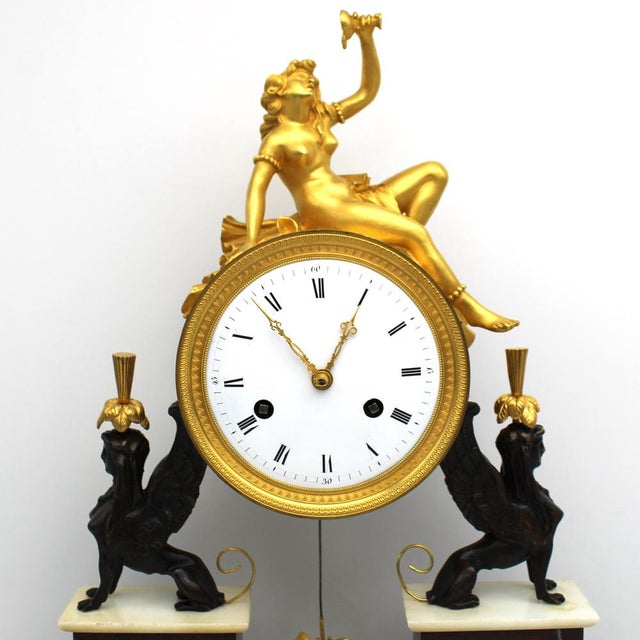 Directory pendulum clock. In golden bronze, burnished bronze and marble - mercury gilding, movement with flush suspension....