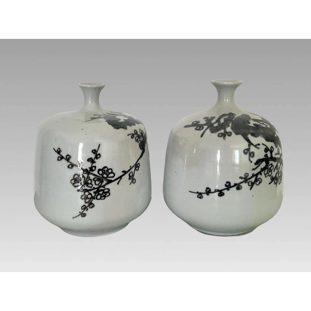 A pair of unusual Japanese hand thrown and decorated pale grey/white celadon ceramic vases, with sweeping Cherry Blossom...