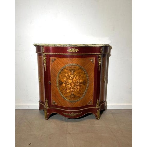 The central panel showcases a delicate floral inlay framed by geometric veneer work, creating a striking contrast in tones...