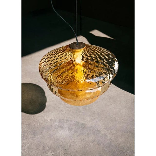 Tima pendant light by luca nichetto materials: shade: clear/grigio kaiser/amber mouth blown glass structure: bronze satin,...
