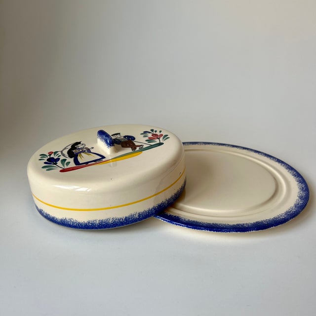 This vintage lidded serving dish features hand-applied enamel decoration consistent with the folk-art style of the...