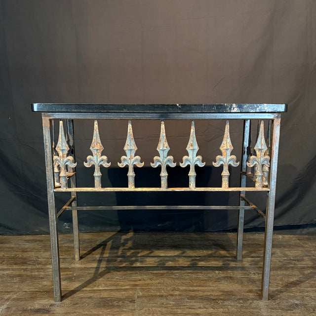 A French console table crafted from an antique wrought iron balcony railing and marble from the 19th century featuring...