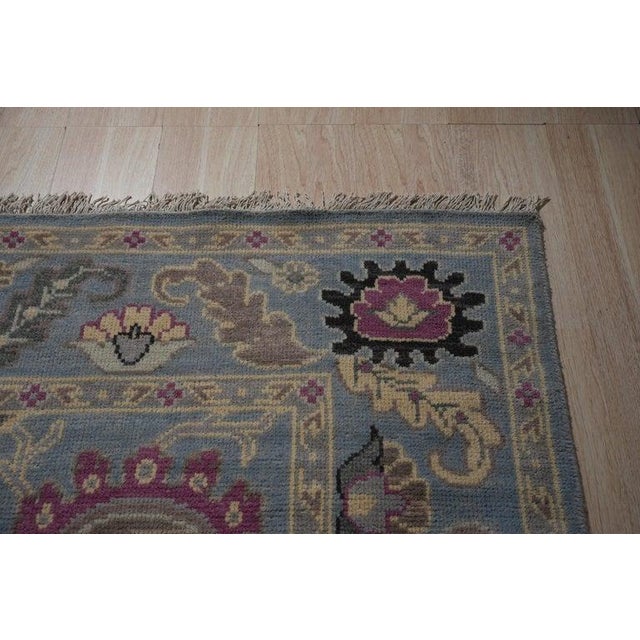 This hand knotted pile rug features a classic traditional design rendered in primary blue tones. Constructed from wool,...
