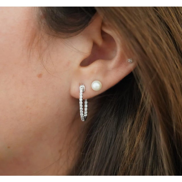 Simple and elegant natural diamond classic hoop earrings set in 14k Solid Gold for long-lasting and durable use. Hinged...