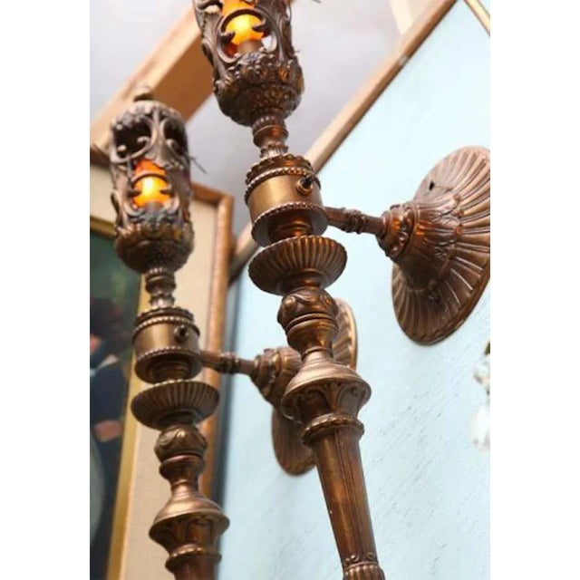 A spectacular pair of articulated aged copper, formerly gas lit converted to electricity- wall mounted torchieres sconces...