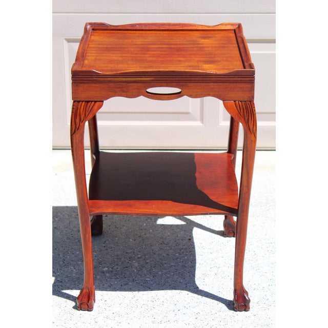 Refined and timeless, this vintage Georgian-style mahogany tray-top side table, circa 1950s–1970s, showcases elegant...