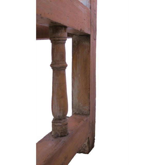 Spanish Colonial pine settle bench with spindle back and lower apron. Down curved arms with spindle supports. Mortise and...