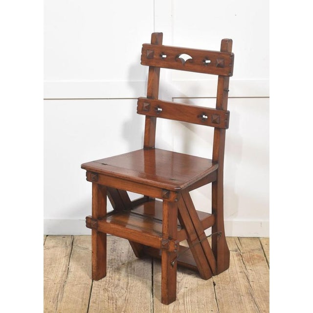 This beautifully crafted metamorphic library chair is made from solid walnut, prized for its rich color and fine grain....