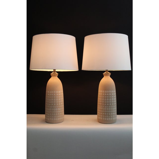 Unusual pair of Accolay style lamps. Textured finish with geometric inlay design. Both creating depth in each piece....