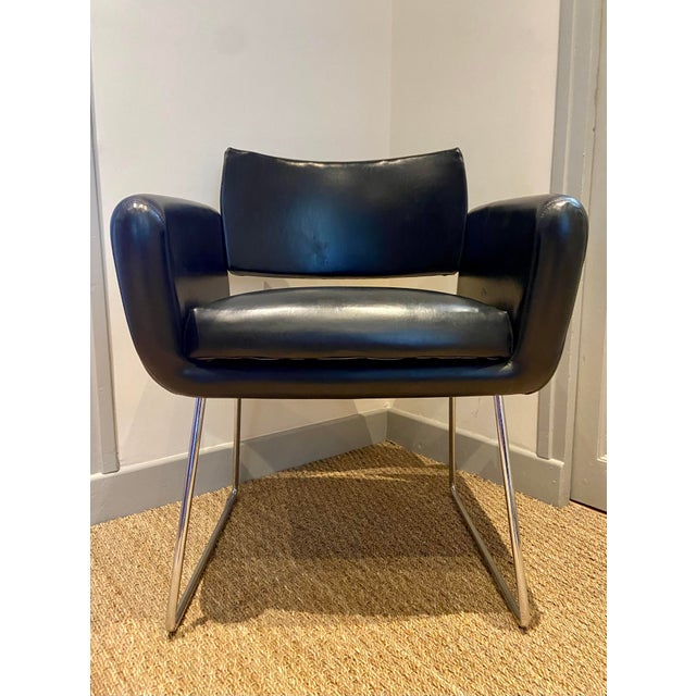 This elegant mid-century armchair was produced in France by Steiner and is attributed to the renowned designer Joseph-...