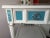 Hollywood Regency style white and blue lacquered side tables/nightstands. They are one-drawer with an original heavy...