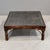 Carved Indian teak & iron coffee table with turned legs. The rich, dark brown teak table top provides an unusual surface...