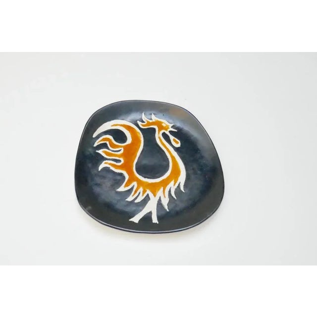 Highly decorative mid-century pottery wall plaque or plate by le Cyclope art pottery, in the style of Jean Lurcat. The...