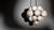 An effervescent cluster of glass spheres cumulates around a pendant brass frame. Majestic and modern, the composition...