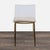 A single piece of thick clear acrylic molds the seat of Mermelada Estudio's dining chair. The chair rests on thin gold-...