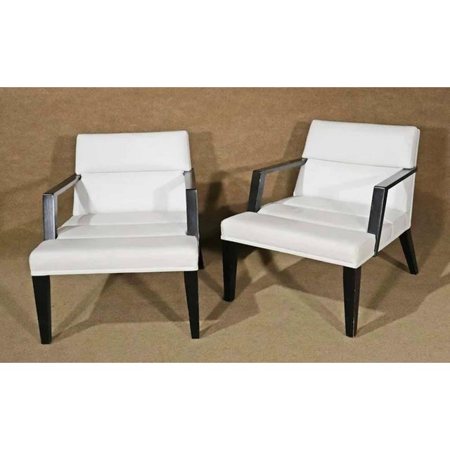 Pair of Mid-Century Modern style low chairs by the Bright Furniture Company. White leather over black wood frame. Simple...
