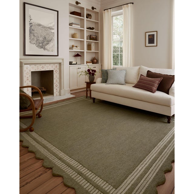 The Scottie Collection from Chris Loves Julia x Loloi is a hand-tufted wool area rug with a playful scalloped edge and...