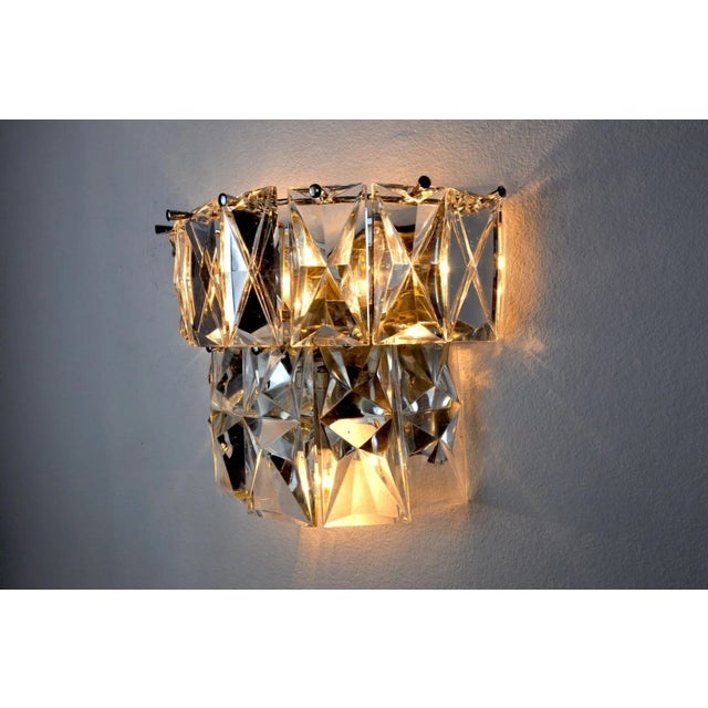 Beautiful kinkeldey wall lamp designed and produced in Germany in the 1970s. Cut crystals distributed on 2 levels of a...