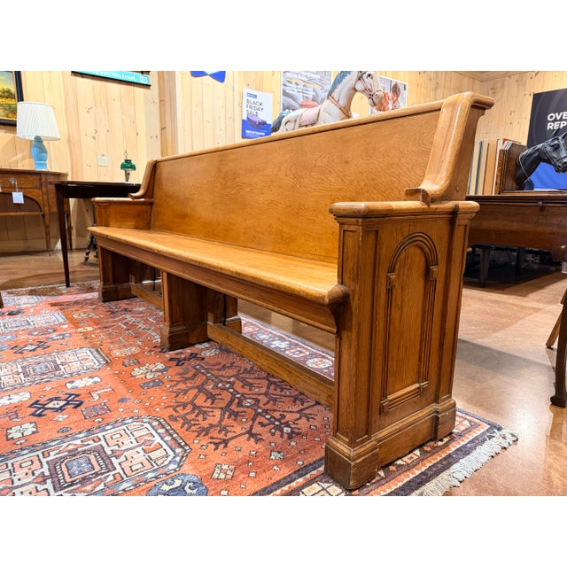 This is a classic vintage wooden church bench pew, crafted in solid wood with a long, straight back and gently shaped arm...