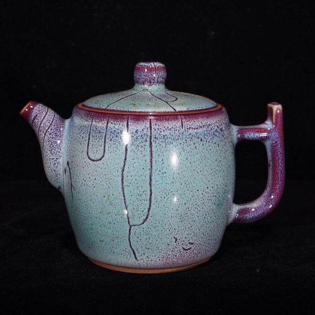 A beautiful 7-piece Chinese Jun ware style porcelain tea set. The set includes one teapot and six matching tea cups. Each...