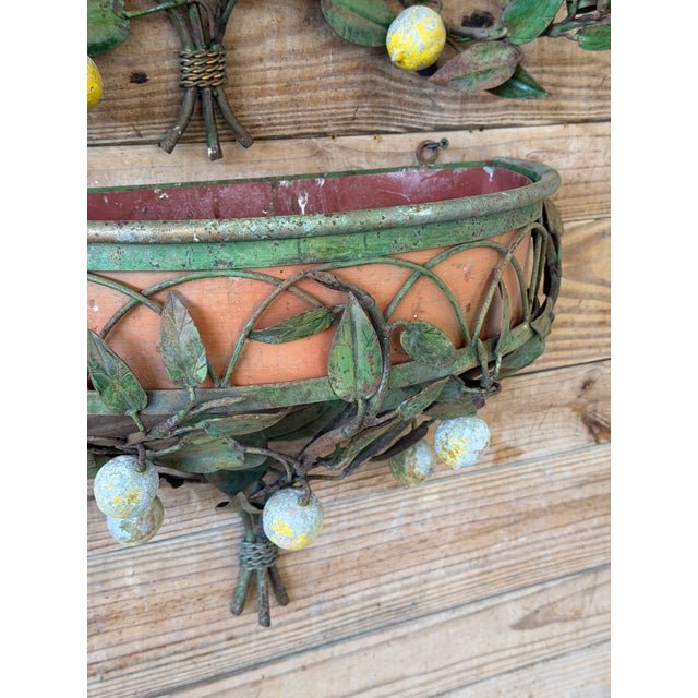 A wonderfully sculptural vintage Italian toleware lemon tree wall jardiniere featuring an exceptionally rare two-piece...