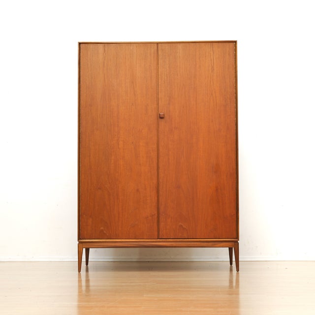 This vintage mid-century armoire was produced by McIntosh Furniture of Kirkcaldy Scotland during the 1960s. Made from teak...