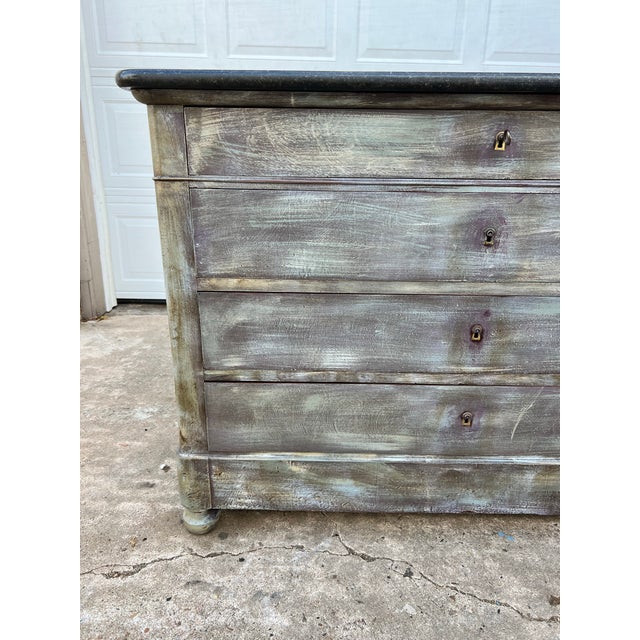 A charming 19th-century French Louis Philippe commode, crafted in walnut with a distressed painted finish and a dark...