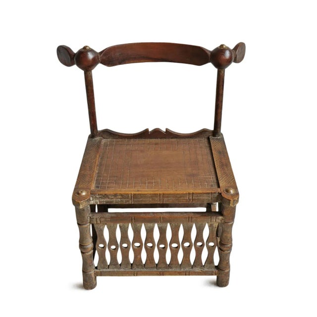 Original antique hand carved wood Chief chair. Beautiful traditional carving and arched back design with brass detail....