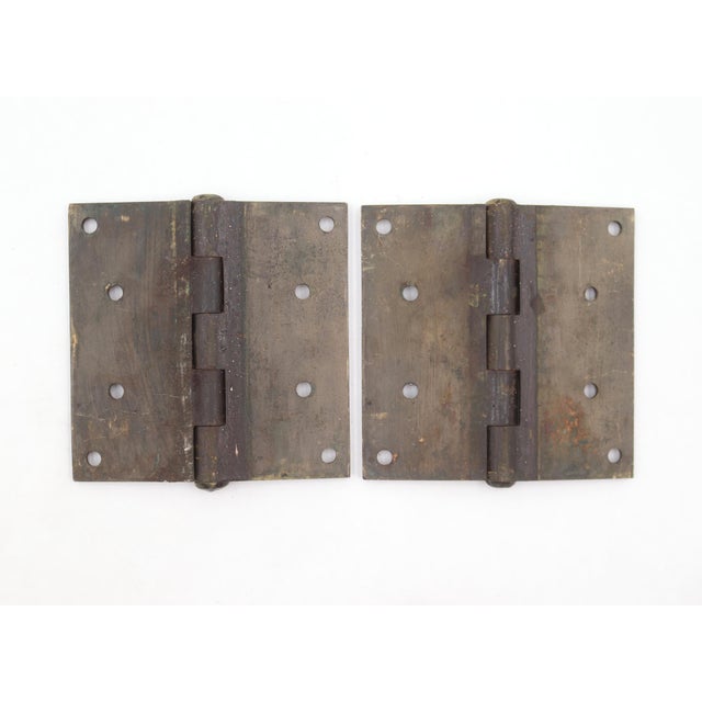 These door hinges are made of cast iron with flat tips, five knuckles, and a template hole pattern. The original mounting...