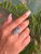 This exquisite ring is beautifully crafted in 925 Sterling Silver, showcasing two oval Blue Topaz gemstones in a refined...