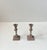 A pair of patinated bronze candlesticks for regular sized candles. Distinct functionalist styling with architectural...