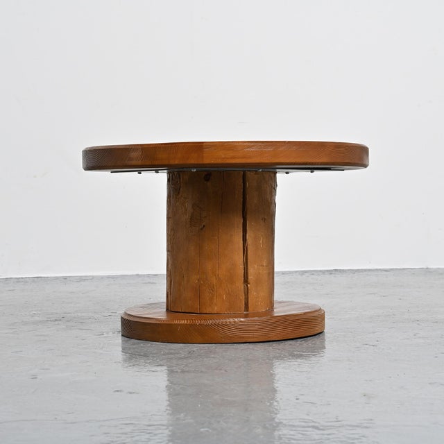 Coffee table made in France in the 1960s. Solid pine frame with a circular base and top.