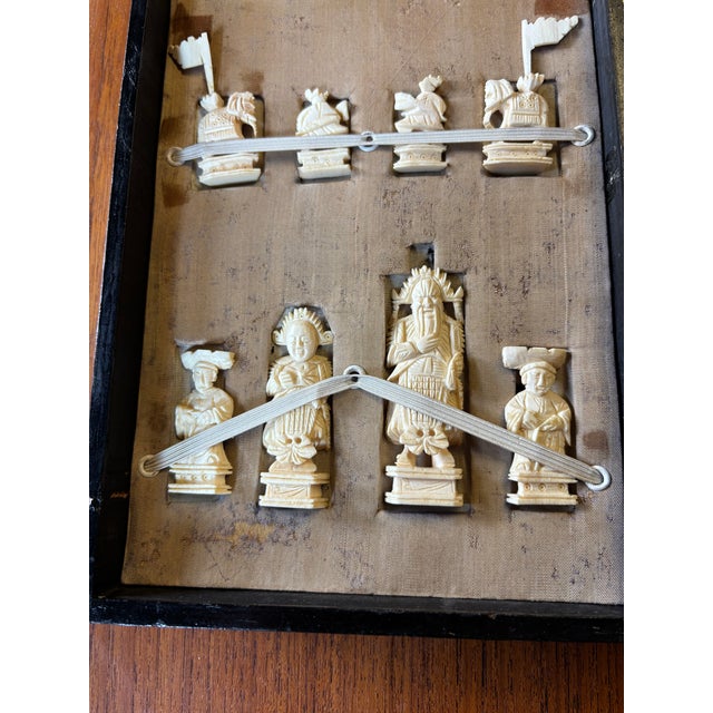 Hand Carved Bone Chess Set with its original box which doubles as a chess board when opened and laid flat.