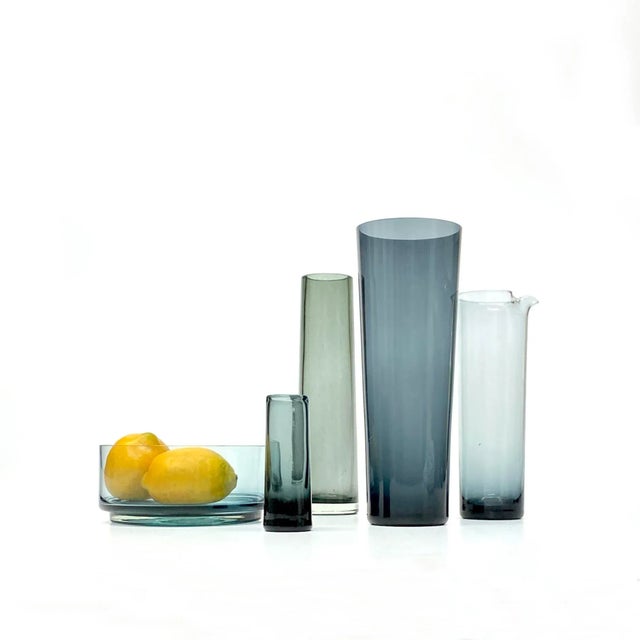 Smokey grey translucent vessels, group of 5. This streamlined set of muted grey translucent glass vessels features minimal...