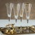 This set of Festivity Champagne Flutes is perfect for chic holiday celebrations. Made from clear glass with gold and black...