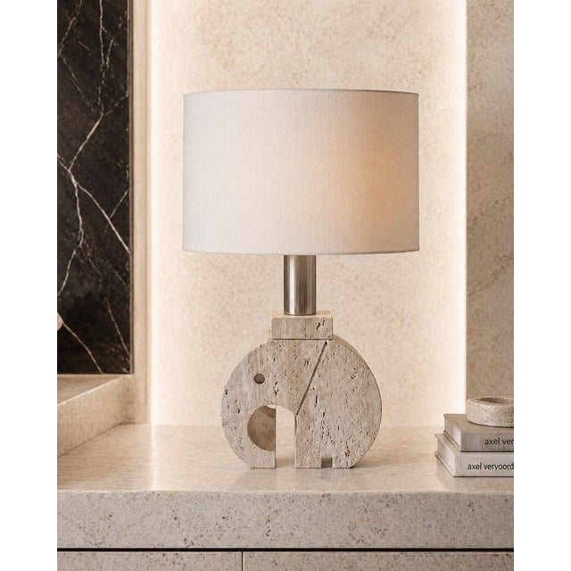 A striking and sculptural vintage table lamp base, masterfully crafted from solid travertine and designed in the form of a...